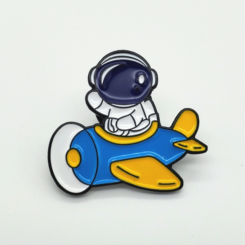 Astronaut on a plane pin